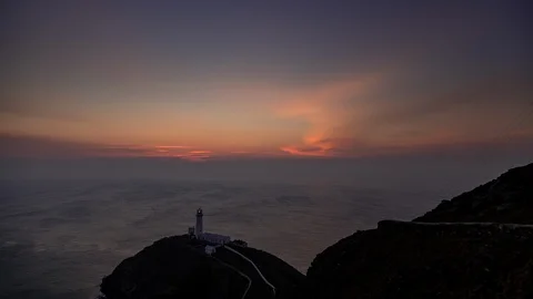5k time lapse colourful sky at dusk over South Stack lighthouse, Anglesey Stock Footage 110289684