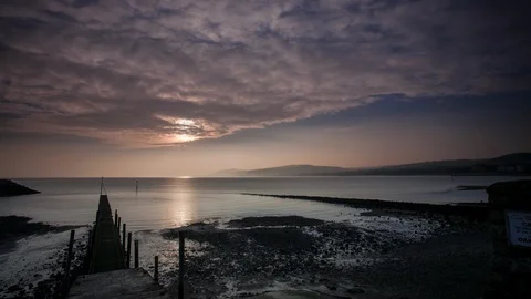 5k time lapse partial solar eclipse and tide, North Wales coast Stock Footage 109795964