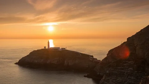 5K time lapse sunset over lighthouse and sea at South Stack, Anglesey, Wales Stock Footage 110297196