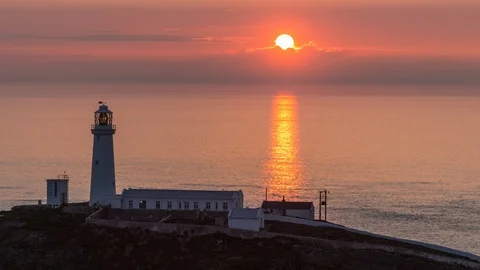 5K time lapse sunset over lighthouse and sea at South Stack, Anglesey, Wales Stock Footage 110298941