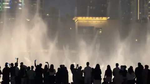 5th April 2025 - Dubai, UAE. People Standing by Dubai Fountain at Night 스톡 동영상 332553928