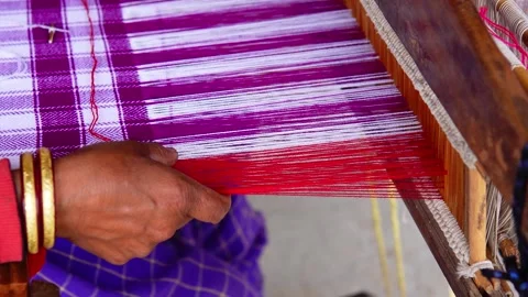 6-04-24; Woman's hand on the shuttle frame weaving a Pattu in an Indian village. Stock Footage 272587810