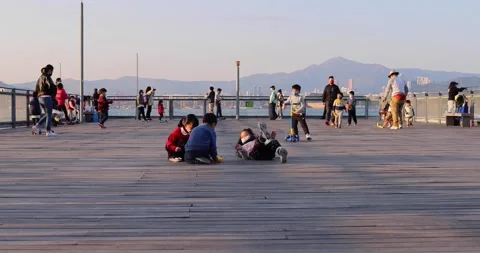 6 2 2022 boy and girl, adults with face masks have fun and relax at pier near Stock Footage 170167768