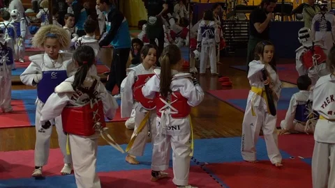 6 and 7 years old kids getting prepared to a taekwondo competition Stock Footage 72107551