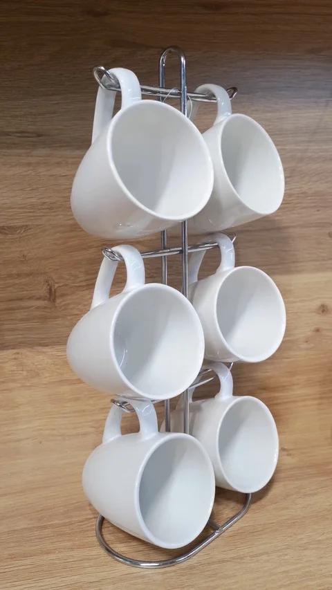 6 empty coffee cups swaying on stand against wooden panels.Invitation for coffee Stock Footage 119664246