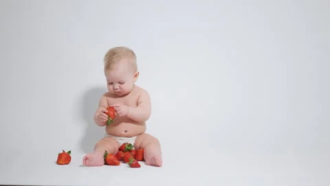 6 month old baby eats red strawberries. concept of healthy food for children, Stock-Footage 242780863