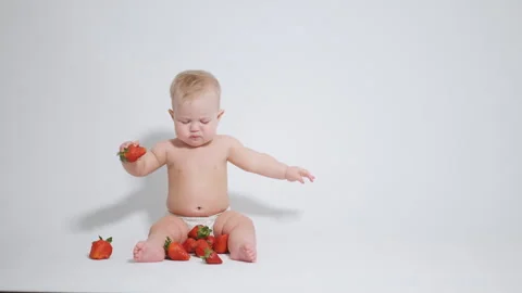 6 month old baby eats red strawberries. concept of healthy food for children, 스톡 동영상 242781003
