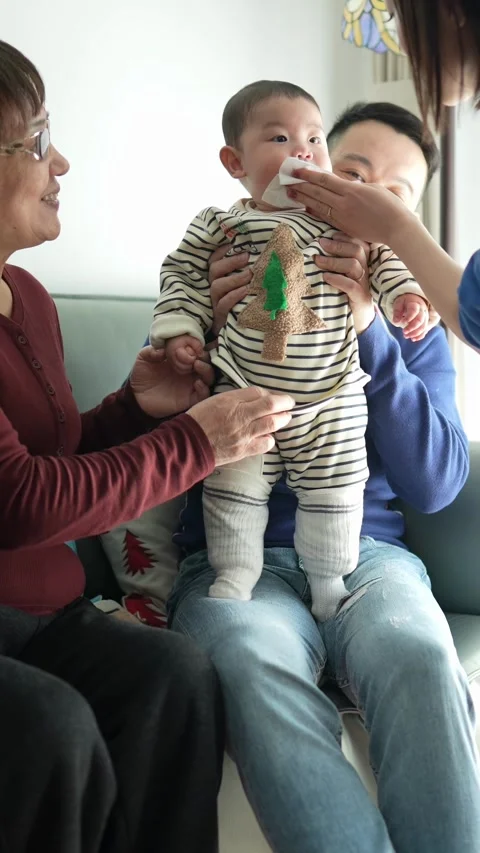 A 6 -month -old baby, a young couple living in Shanghai, China, and grandmother. 스톡 동영상 300741353