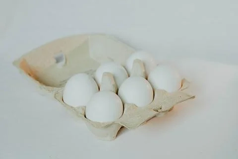 6 white eggs in a cardboard box Stock Photos