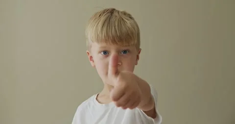 A 6-year-old blond boy shows a thumbs up Video stock 322203283