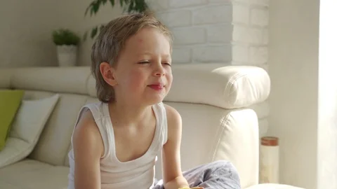 6 year old boy eating green apple and try pull out baby teeth Vídeo Stock 107923710