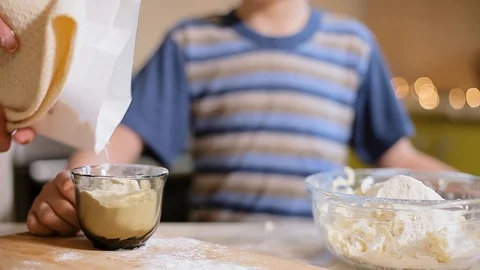 6 year old boy helps mom to cook in the kitchen. Stock Footage 100765456