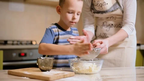 6 year old boy helps mom to cook in the kitchen. Stock Footage 100765545