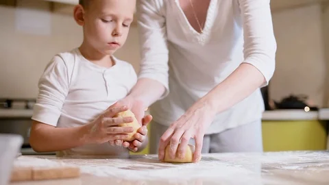 6 year old boy helps mom to cook in the kitchen. Stock Footage 100765651
