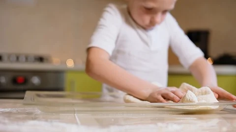 6 year old boy helps mom to cook in the kitchen. Video stock 100765686