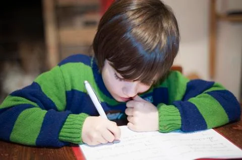 6-year-old child performs homework Stock Photos