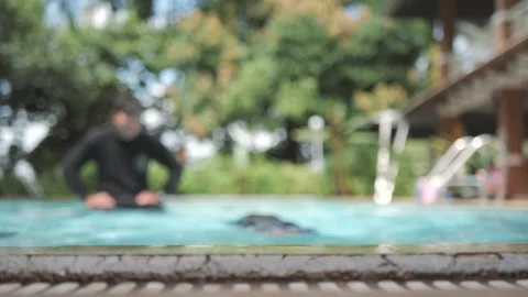 6 years old Asian boy learns to swim by diving and holding his breath. Stock Footage 247367516