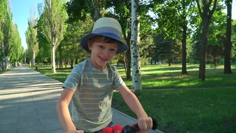 6 years old boy riding a runbike in a park Video stock 134982887