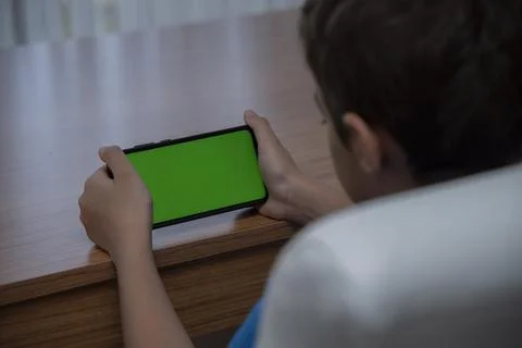 6 years old boy using chroma key smartphone screen Stock Photos
