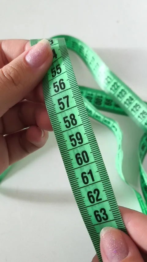 60 centimeters on a centimeter tape. The concept of a thin waist, weight loss. Stock Footage 313978035