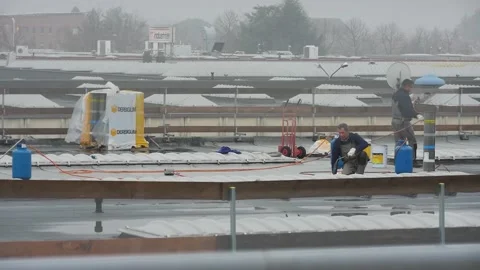 60 sec of workers on the roof working with fire under rain Stock Footage 145471249