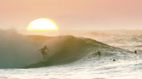 60p Slow motion surfer with big setting sun disk in UHD Video stock 46413816