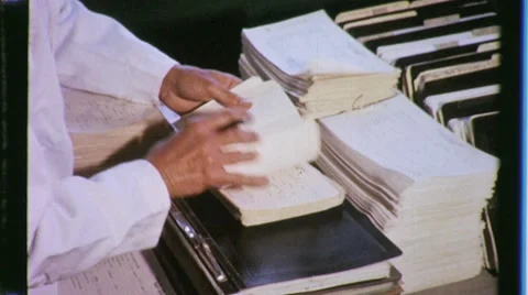 60s Man Sorts Stack Pile of Files Paperwork OFFICE Corporate Vintage Film Movie Stock Footage 8959638
