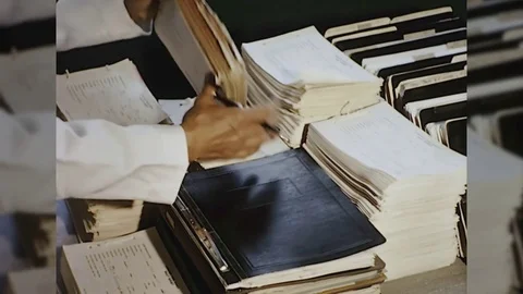 60s Man Sorts Stack Pile of Files Paperwork OFFICE Corporate Vintage Film Movie Stock Footage