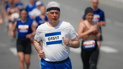 60s runner at marathon. Old man run fast. Senior sportsman jogging Elder athlete Stock Footage 308160422