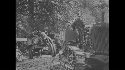 60th Coast Artillery troops use tractors to pull French 155 mm guns from the mud Stock Footage 93739466