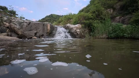 61 Low angle view of clear mountain stream flowing over rocky bed Stock Footage 345459662