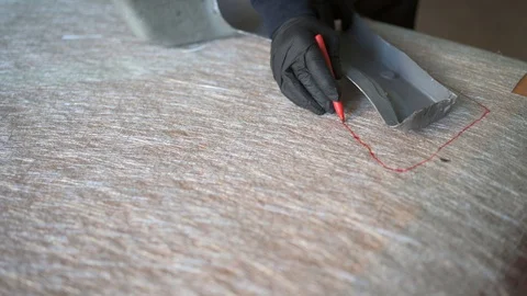 62 year old man cutting fiber with scissors in the workshop. Stock Footage 122253854