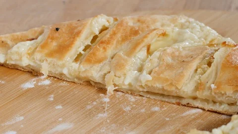 63 Closeup georgian bakery chef demonstrates just baked khachapuri with chees Stock Footage 103322014