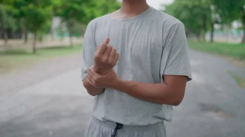 63 WRITECODE,KIRKYoung man warms up his wrists and body toning and strengthening Stock Footage 283186991