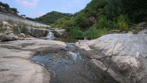 64 Low angle view of clear mountain stream flowing over rocky bed Stock Footage 345461245