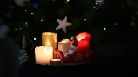 654 Video of beautiful lighted Christmas candles and a tiny sleeping Santa st Video stock 80678345