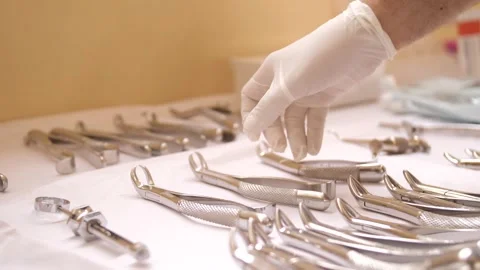 66 Dentist Picks Up Tool From Table Vídeo Stock 347852934