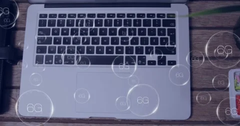 6G technology concept animation over laptop keyboard on wooden desk Stock Footage 327064685