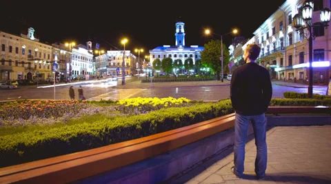 6K (!!!) &amp; 4K &amp; HD. The man stands by the night city street. RAW video output. Video stock 37694668