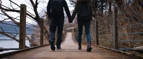 6K - Couple Walking Across a Bridge Holding Hands Stock Footage 125698481
