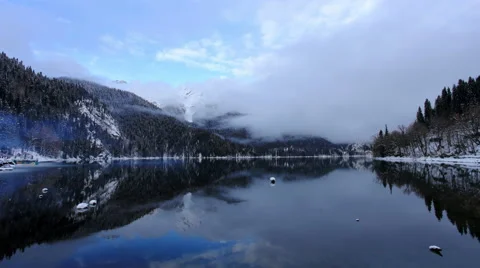6K. Sunset on an alpine lake Ritsa winter under gloomy clouds, Abkhazia,  Stock Footage 59393260