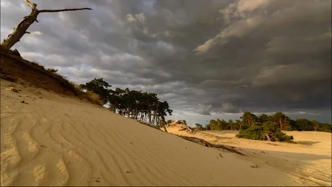 6K Timelapse of dramatic clouds moving over sand dunes landscape Stock Footage 94628363