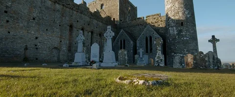6K - Wide View of a Castle and Cemetery in Ireland Stock Footage 123376342