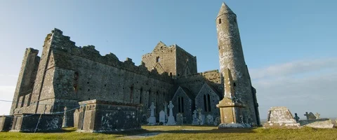 6K - Wide View of a Castle and Cemetery in Ireland Stock Footage 123376911