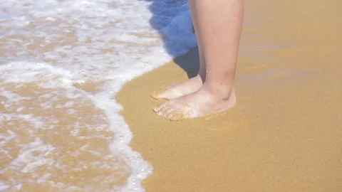 6x slow motion of wave hitting woman feet Stock Footage 87892840