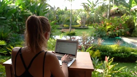 7 in 1 Girl working online with her laptop in a colorful garden Stock Footage 93892553