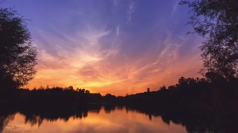 7 in 1 video! The picturesque sunset (sunrise) above forest near the lake Stock Footage