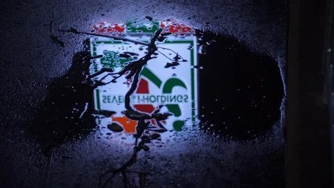 7-11 Sign Reflection in Puddle (1) Stock Footage 95034067