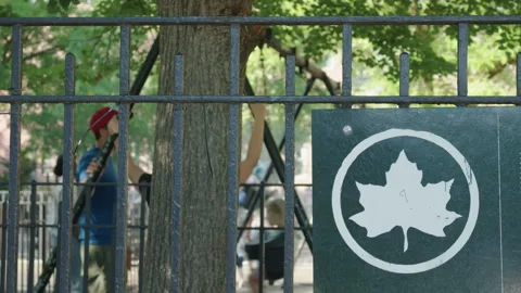 7-20-26, Brooklyn, NY, USA - leaf logo on fence outside swings in public park Stock Footage 340171479