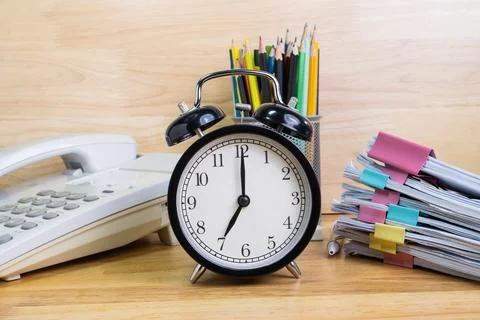 7 AM Clock on work desk in the office Time of business working concepts sel.. Stock Photos